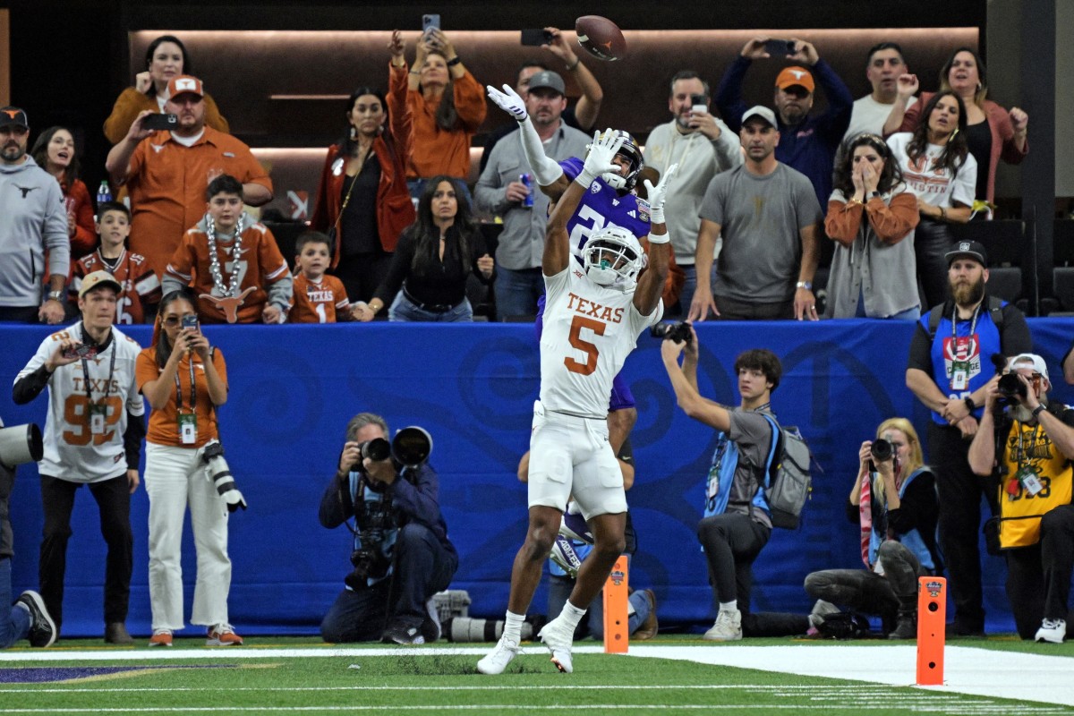 Jan 1, 2024; New Orleans, LA, USA; Washington Huskies cornerback Elijah Jackson (25) knocks the ball away from Texas Longhorns wide receiver Adonai Mitchell (5) during the fourth quarter in the 2024 Sugar Bowl college football playoff semifinal game at Caesars Superdome.