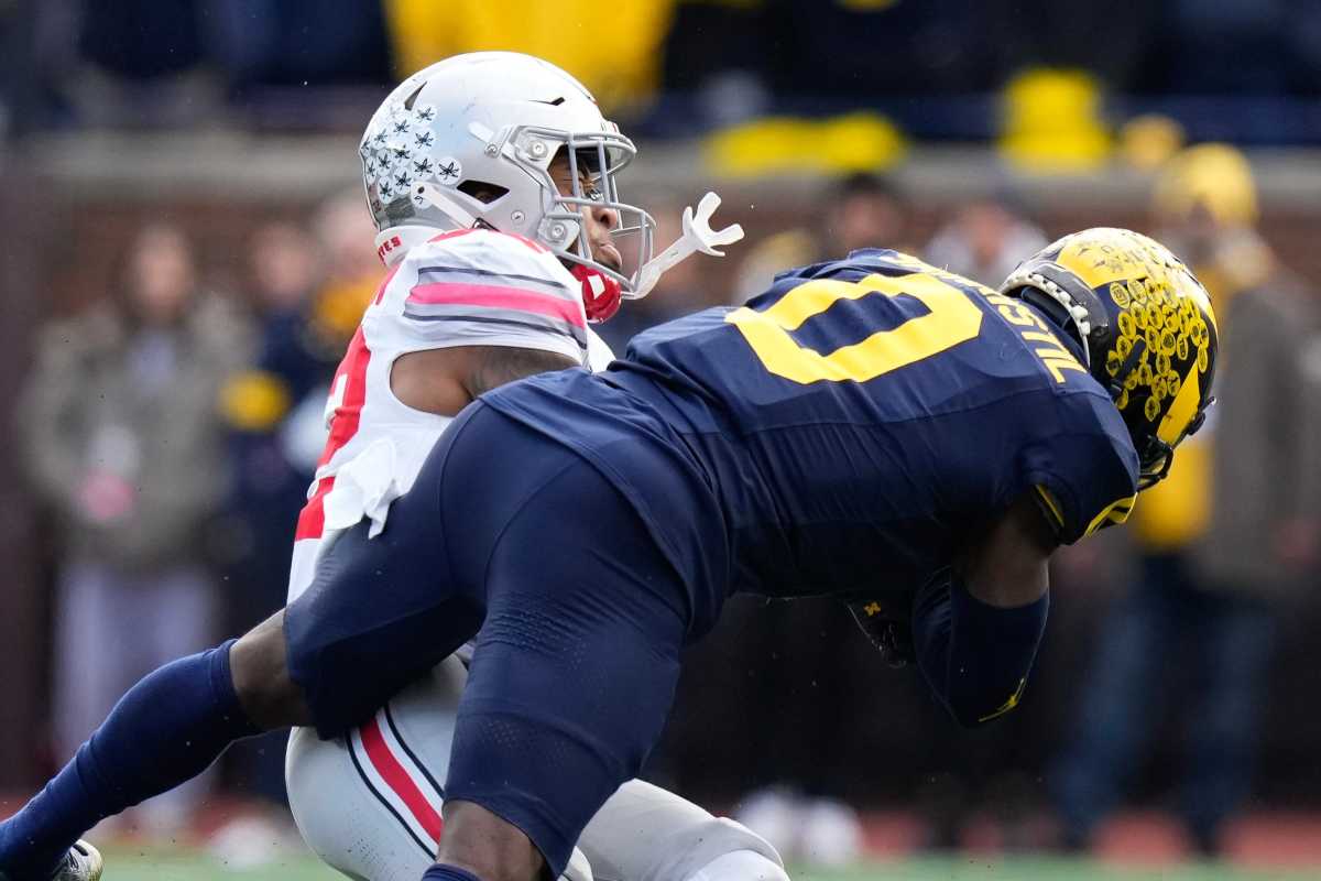 Mike Sainristil delivers a hit against Ohio State