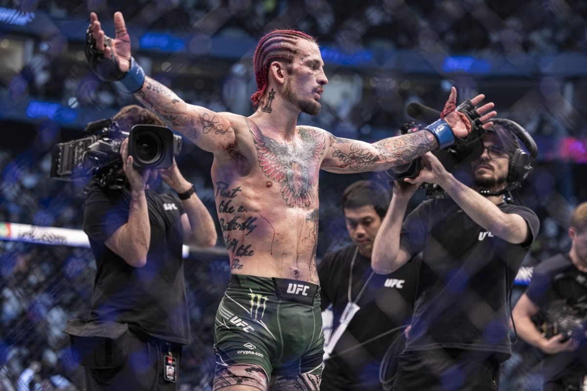 Sean O'Malley (blue gloves) defeats Petr Yan (red gloveS) during UFC 280