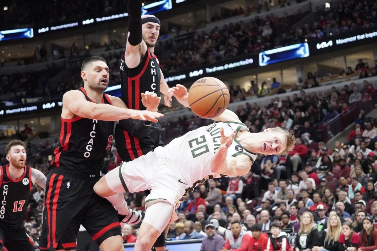 Chicago Bulls center Nikola Vucevic (9) flagrantly fouls Milwaukee Bucks guard AJ Green (20) 
