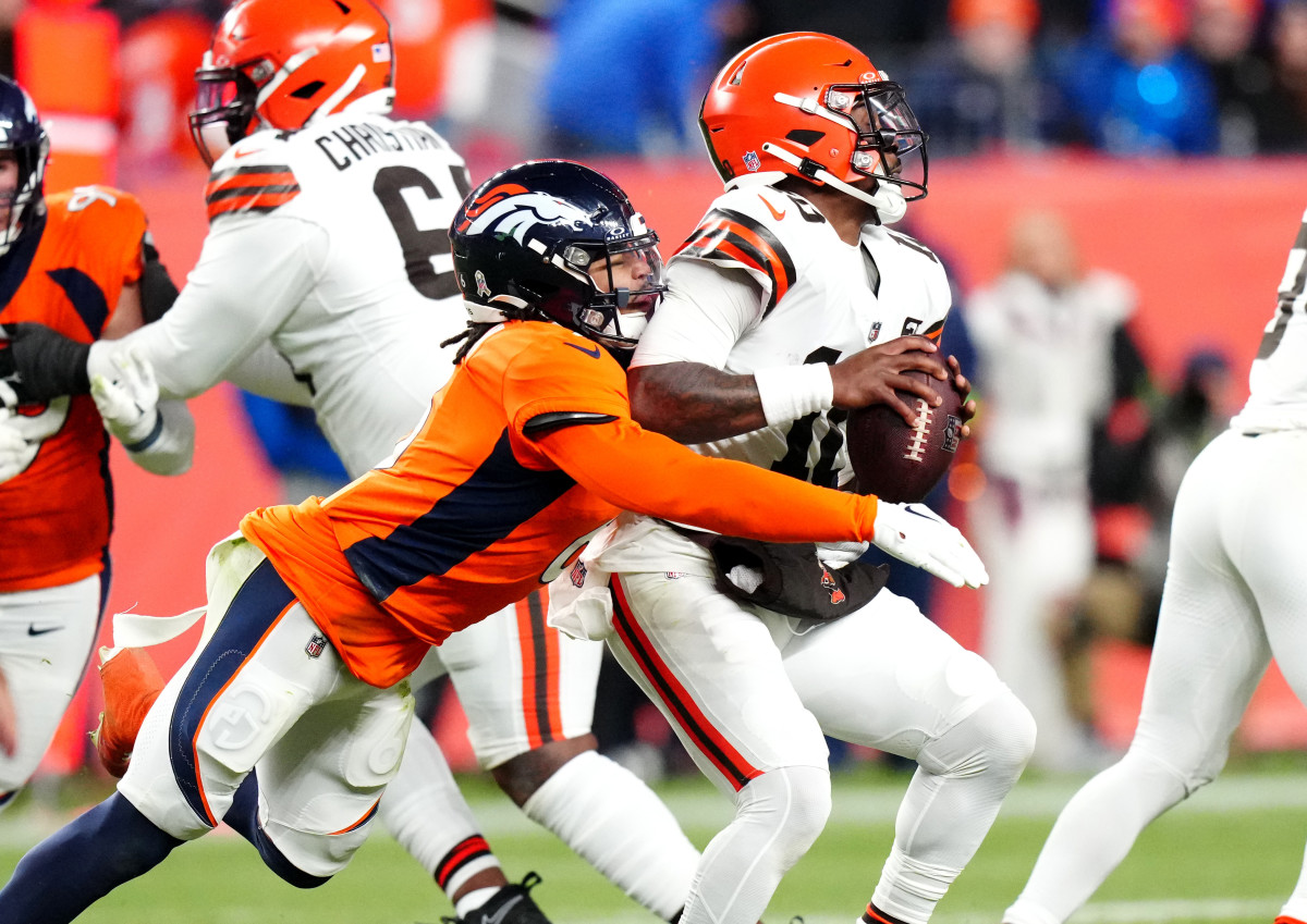 Nov 26, 2023; Denver, Colorado, USA; Denver Broncos safety P.J. Locke (6) sacks Cleveland Browns quarterback PJ Walker (10) in the fourth quarter at Empower Field at Mile High. Mandatory Credit: Ron Chenoy-USA TODAY Sports