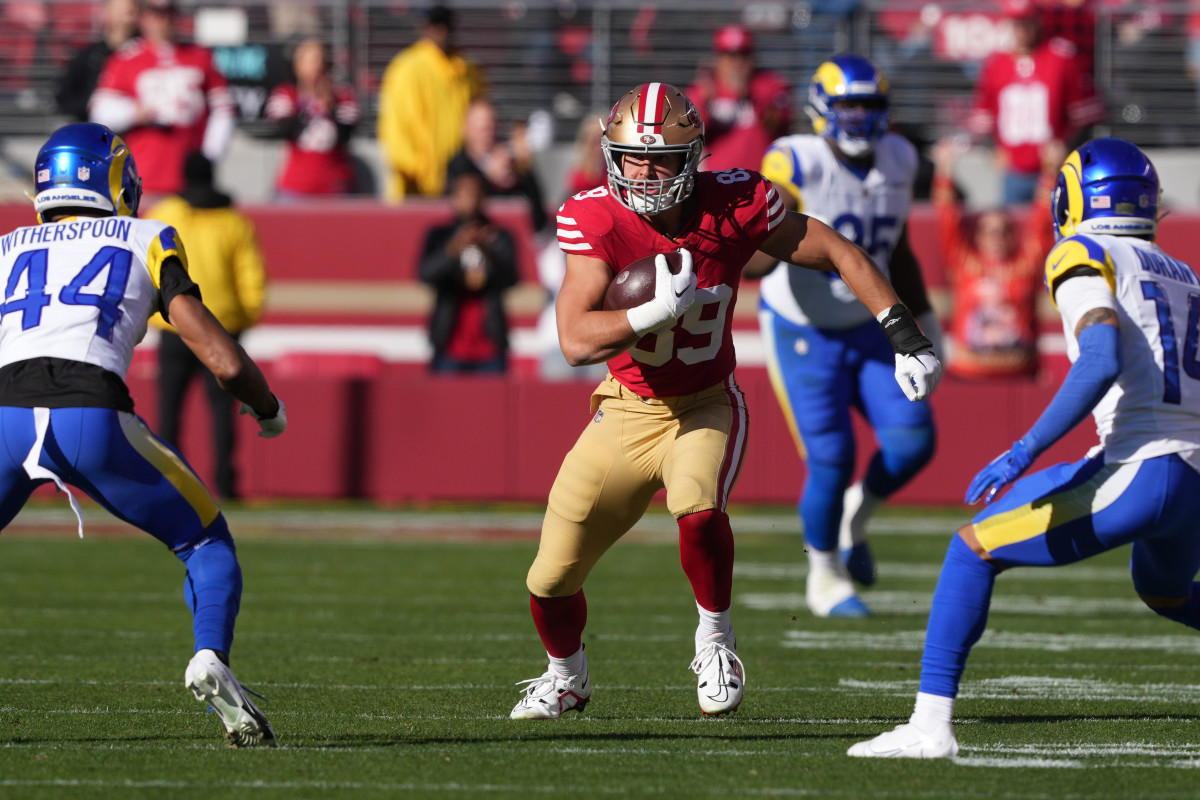 Jan 7, 2024; Santa Clara, California, USA; San Francisco 49ers tight end Charlie Woerner (center) runs after a catch against Los Angeles Rams cornerbacks Ahkello Witherspoon (44) and Cobie Durant (14) during the first quarter at Levi's Stadium. Mandatory Credit: Darren Yamashita-USA TODAY Sports