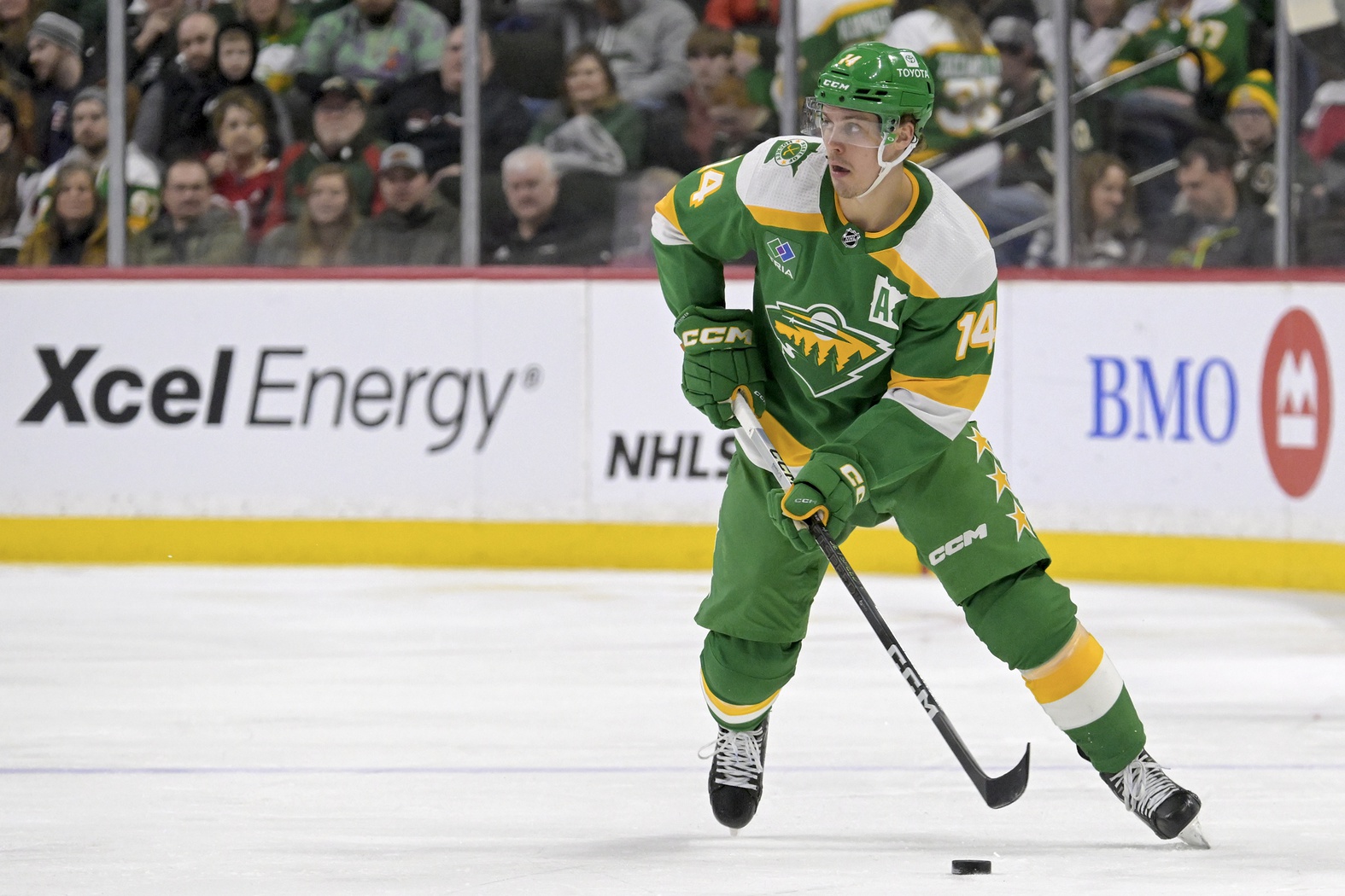 Feb 17, 2024; Saint Paul, Minnesota, USA; Minnesota Wild forward Joel Eriksson Ek (14) skates with the puck against the Buffalo Sabres during the second period at Xcel Energy Center.