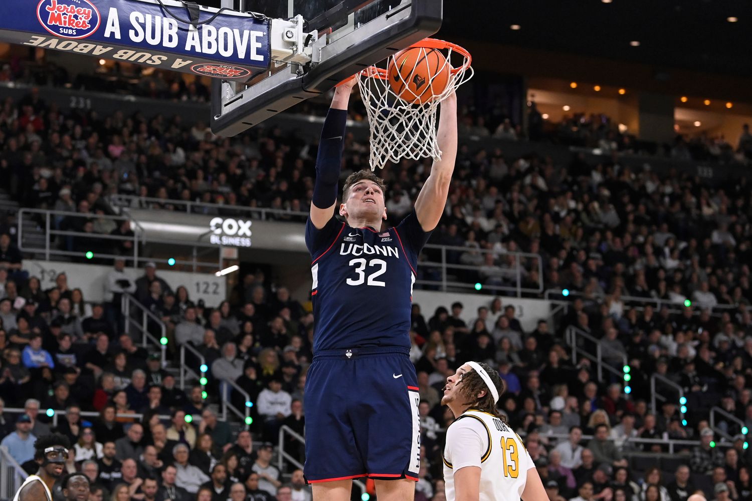 Mar 9, 2024; Providence, Rhode Island, USA; Connecticut Huskies center Donovan Clingan (32) dunks the ball against the Providence Friars during the second half at Amica Mutual Pavilion. Mandatory Credit: Eric Canha-USA TODAY Sports