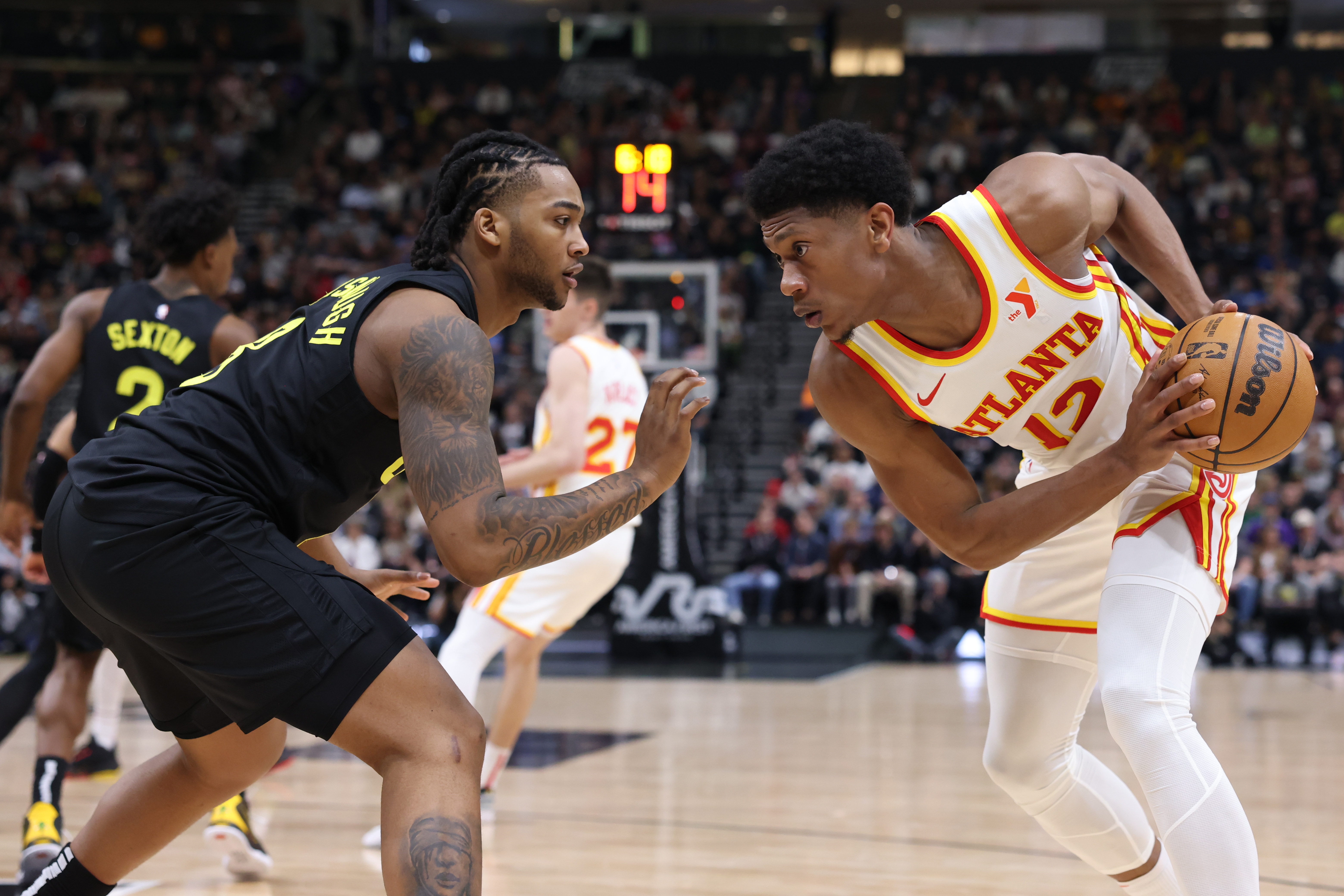 Mar 15, 2024; Salt Lake City, Utah, USA; Atlanta Hawks forward De'Andre Hunter (12) looks to move the ball against Utah Jazz forward Brice Sensabaugh (8) during the second quarter at Delta Center. Mandatory Credit: Rob Gray-USA TODAY Sports