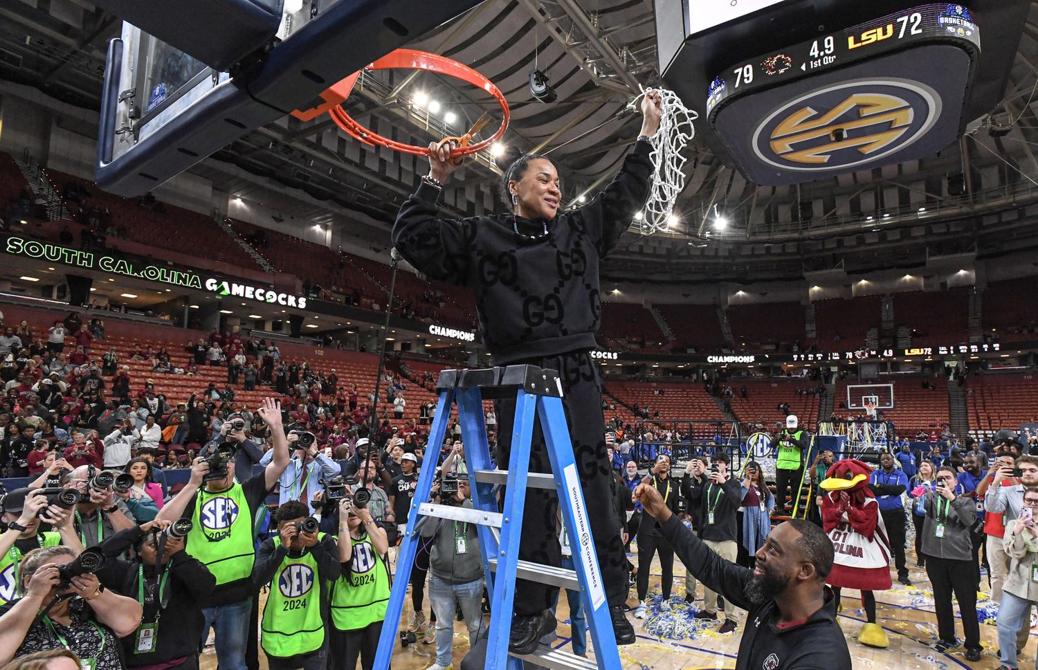 Dawn Staley holds the cut-down net from the Gamecocks SEC Tournament Title win over LSU (10th Mar., 2024)