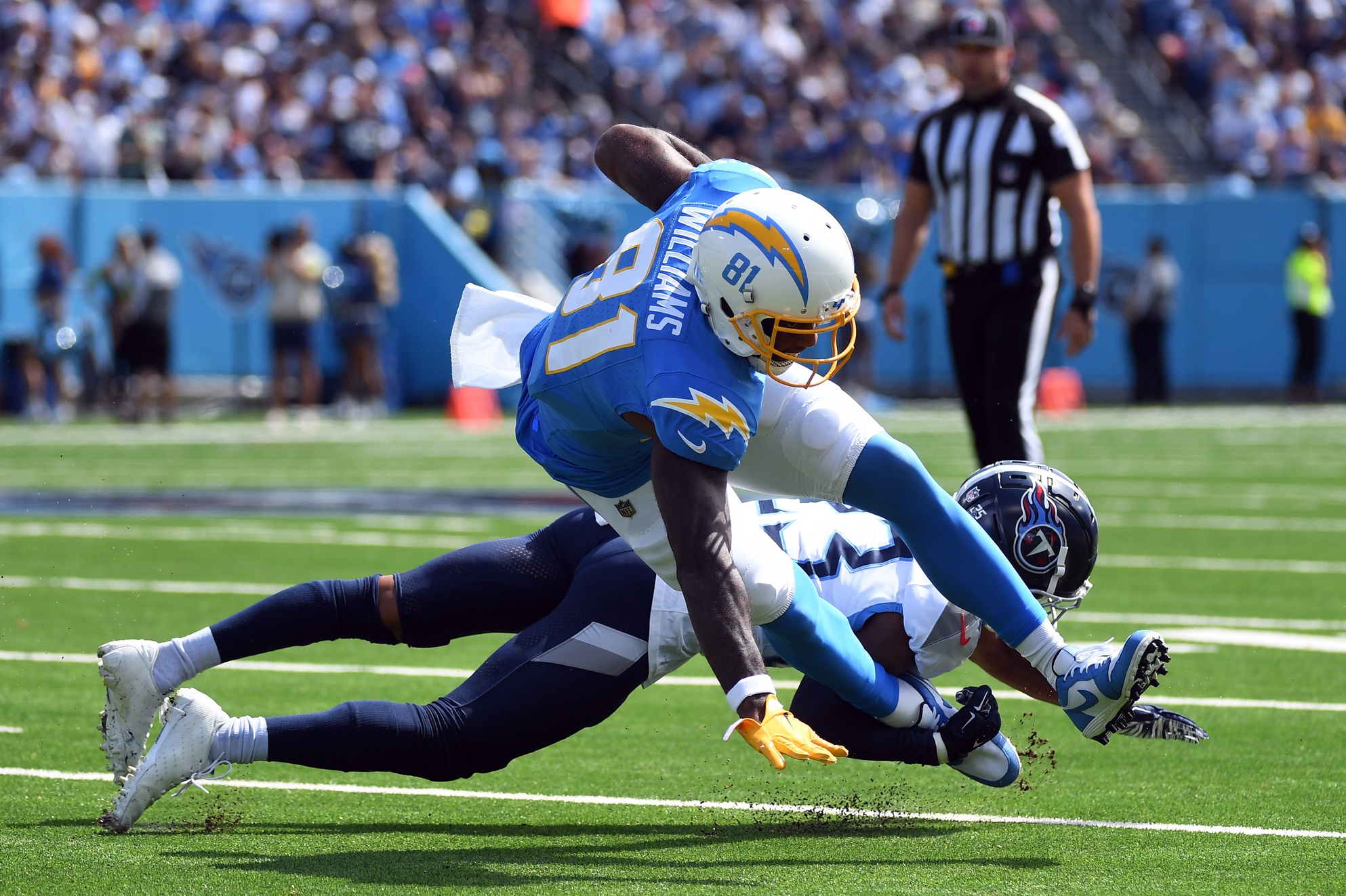Sep 17, 2023; Nashville, Tennessee, USA; Los Angeles Chargers wide receiver Mike Williams (81) is tackled behind the line by Tennessee Titans cornerback Tre Avery (23) during the first half at Nissan Stadium.