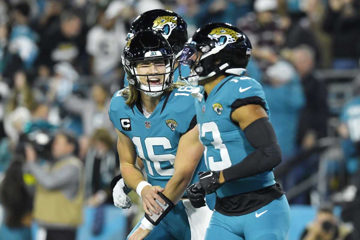 Trevor Lawrence yells in celebration with teammate wide receiver Christian Kirk