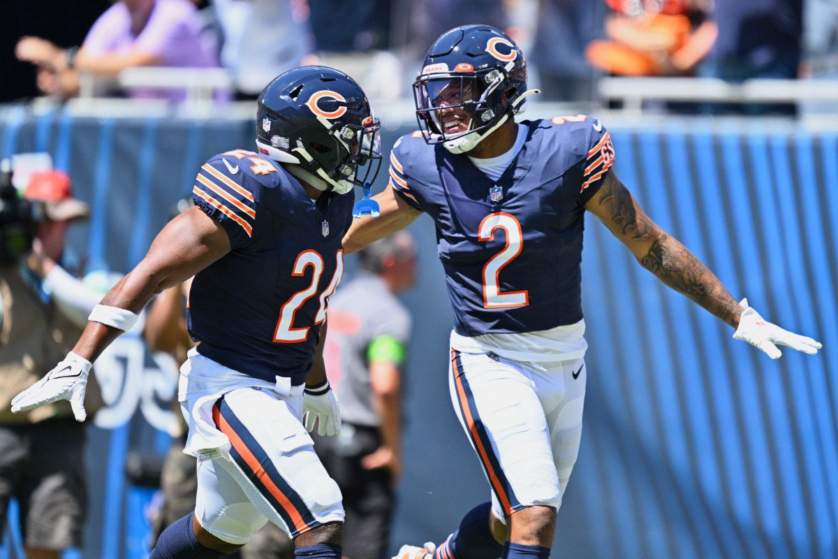 DJ Moore and Khalil Herbert run looking at each other with their arms out wide in celebration
