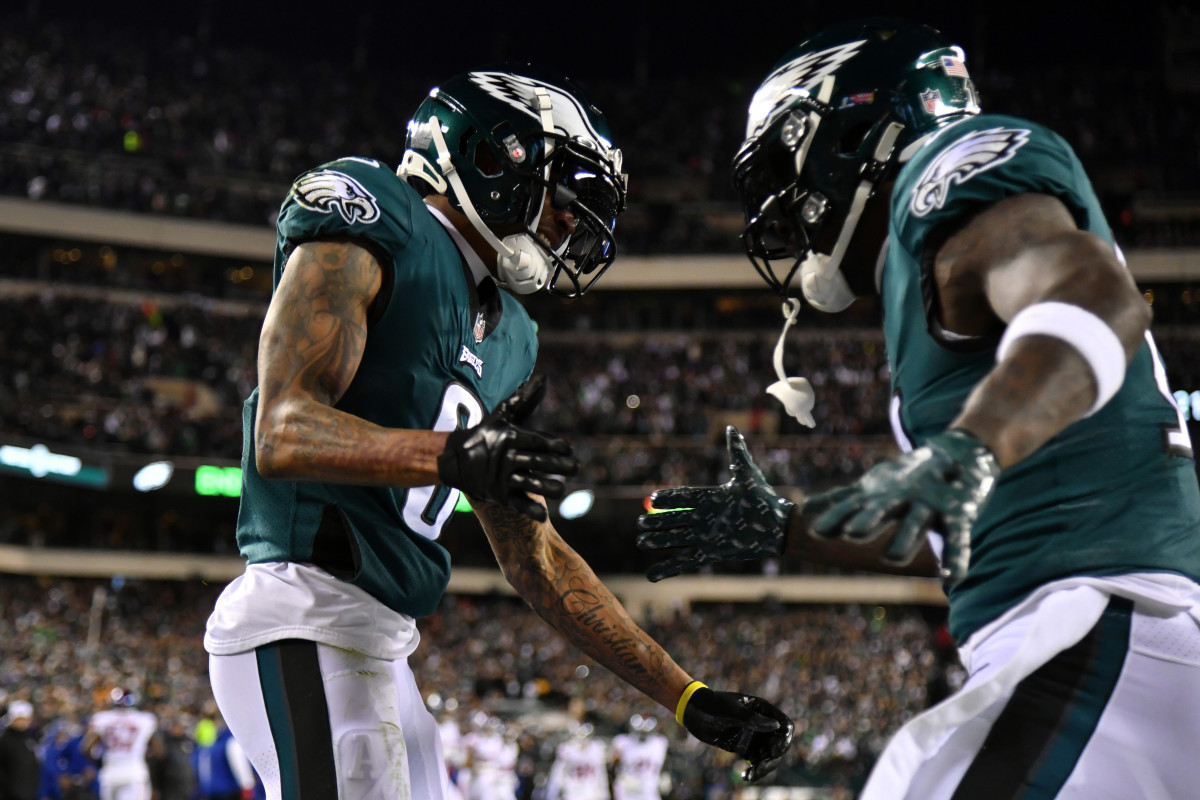 DeVonta Smith and A.J. Brown put their hands out to clap each others in celebration