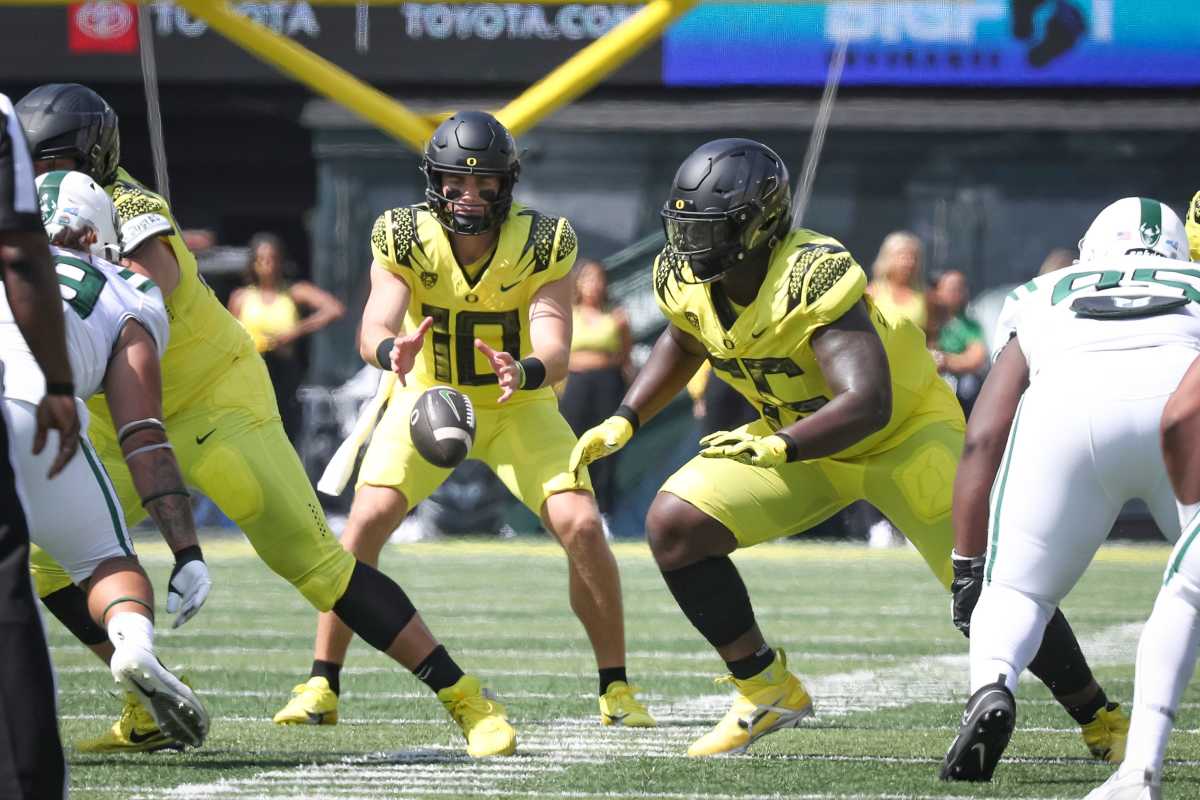 Oregon Ducks quarterback Bo Nix fields a snap against the Portland State Vikings.