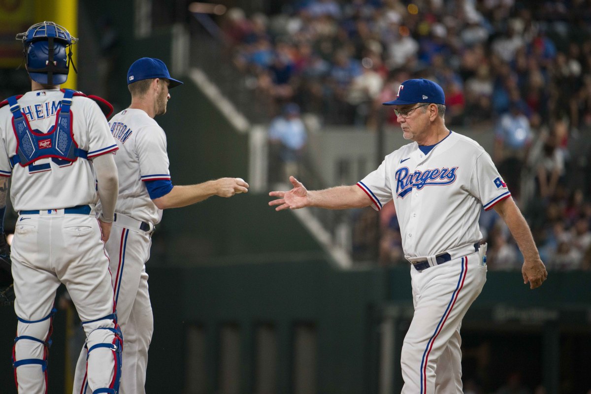 Sep 6, 2023; Arlington, Texas, USA; Texas Rangers manager Bruce Bochy (15) takes the ball from Texas Rangers relief pitcher Chris Stratton (35) during the game against the Houston Astros at Globe Life Field. Mandatory Credit: Jerome Miron-USA TODAY Sports