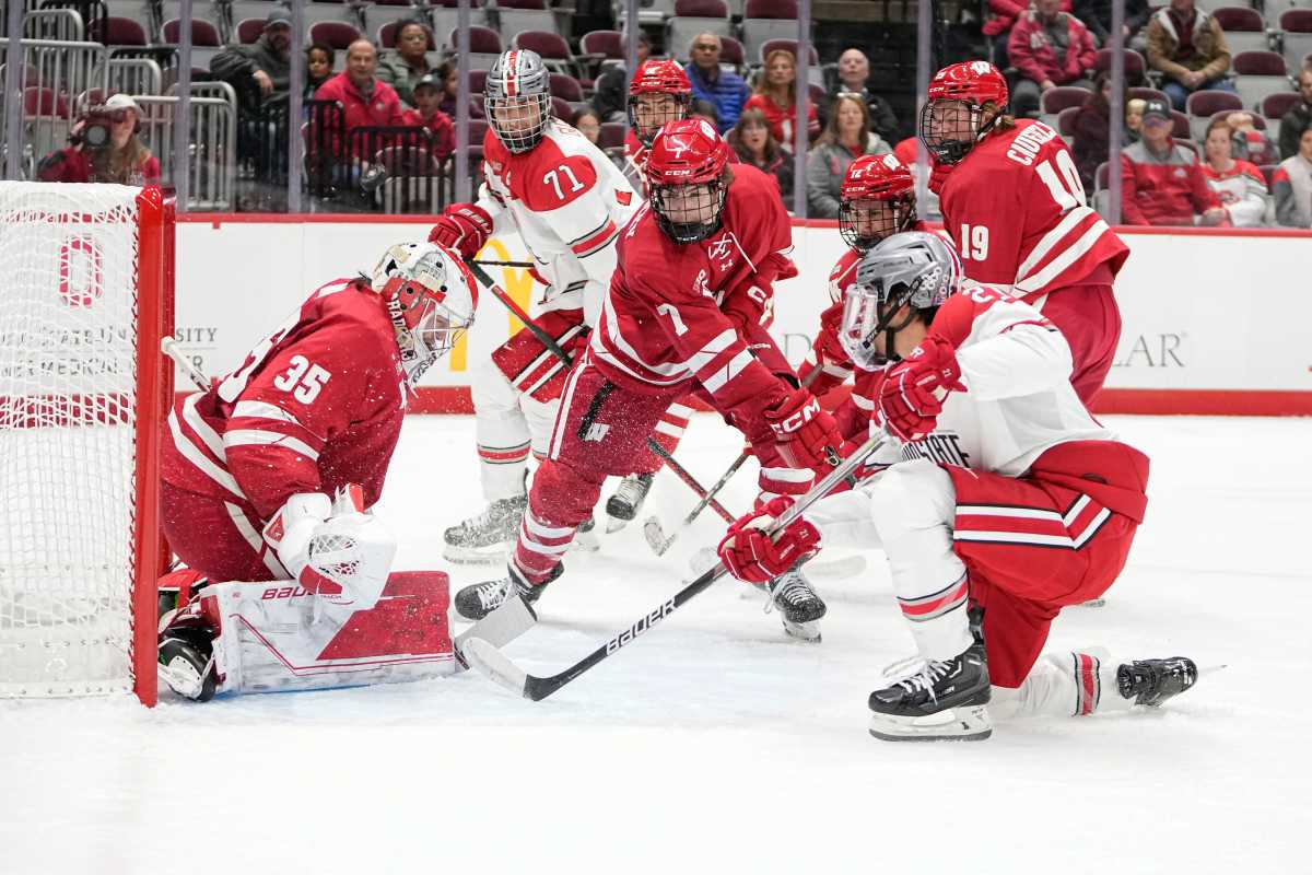 Oct 7, 2022; Columbus, Ohio, USA; Wisconsin Badgers goalie Jared Moe (35) stops a shot from Ohio State Buckeyes forward Joe Dunlap (21) during the NCAA men's hockey game at the Schottenstein Center. Mandatory Credit: Adam Cairns-The Columbus Dispatch Ncaa Hockey Wisconsin Vs Ohio State