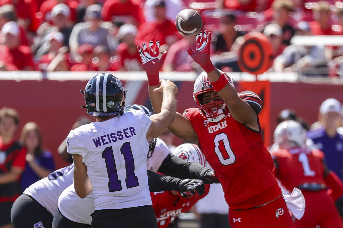 Sep 16, 2023; Salt Lake City, Utah, USA; Utah Utes defensive end Logan Fano (0) pressures Weber State Wildcats quarterback Kylan Weisser (11) in the second half at Rice-Eccles Stadium. Mandatory Credit: Rob Gray-USA TODAY Sports
