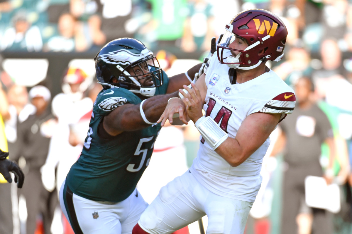 Washington Commanders quarterback Sam Howell (14) is hit by Philadelphia Eagles defensive end Brandon Graham (55) in overtime at Lincoln Financial Field.