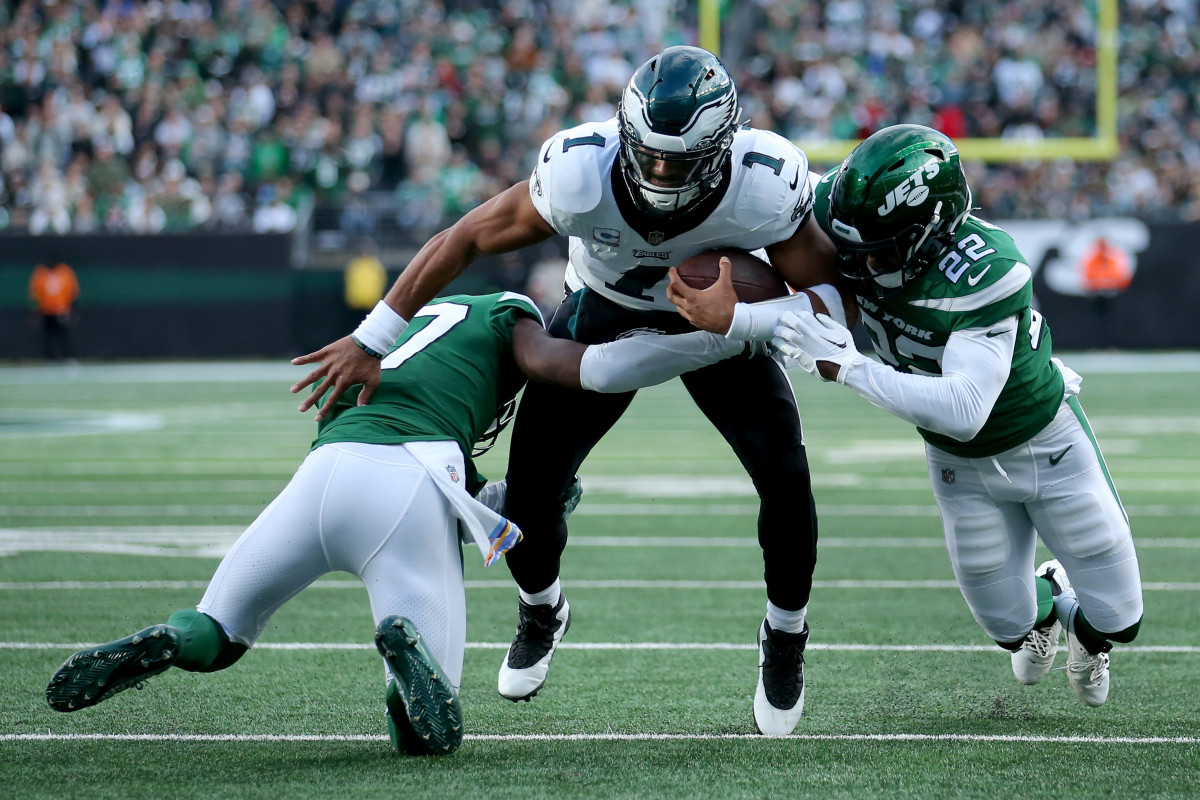 Philadelphia Eagles quarterback Jalen Hurts (1) is tackled by New York Jets cornerback Bryce Hall (37) and safety Tony Adams (22) during the first quarter at MetLife Stadium.