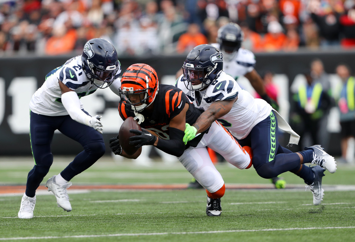 Cincinnati Bengals wide receiver Tyler Boyd (83) makes the diving reception as Seattle Seahawks cornerback Devon Witherspoon (21) and safety Quandre Diggs (6) defend on the play during the second quarter at Paycor Stadium.