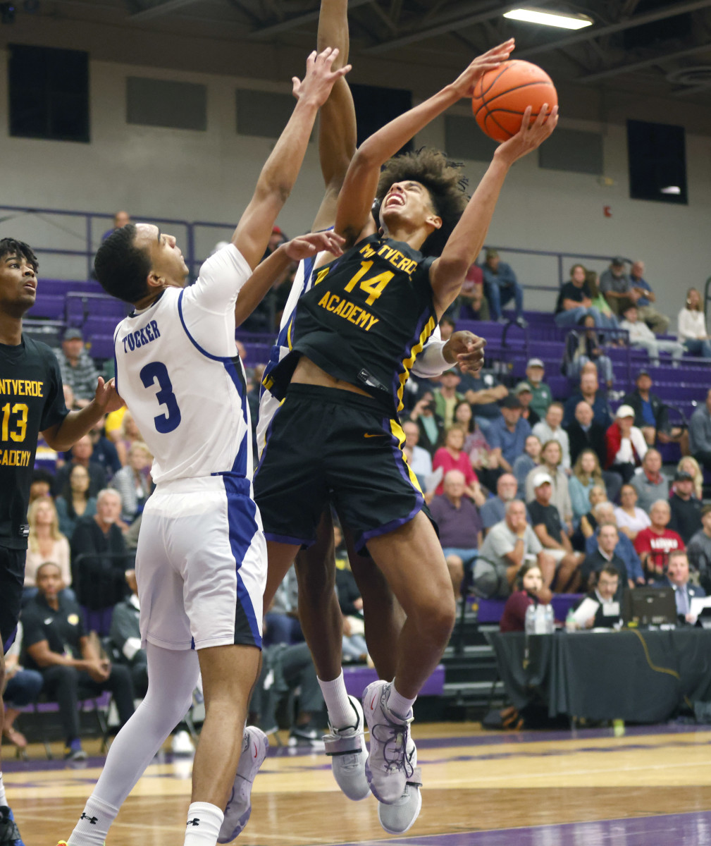 Dec 1, 2022; Montverde, Florida, USA; Montverde Academy forward Asa Newell (14) shoots past IMG Academy forward Bryson Tucker (3) during the second half of the Sunshine Classic basketball tournament at Mills Championship Court on the campus of Montverde Academy. Mandatory Credit: Reinhold Matay-USA TODAY Sports