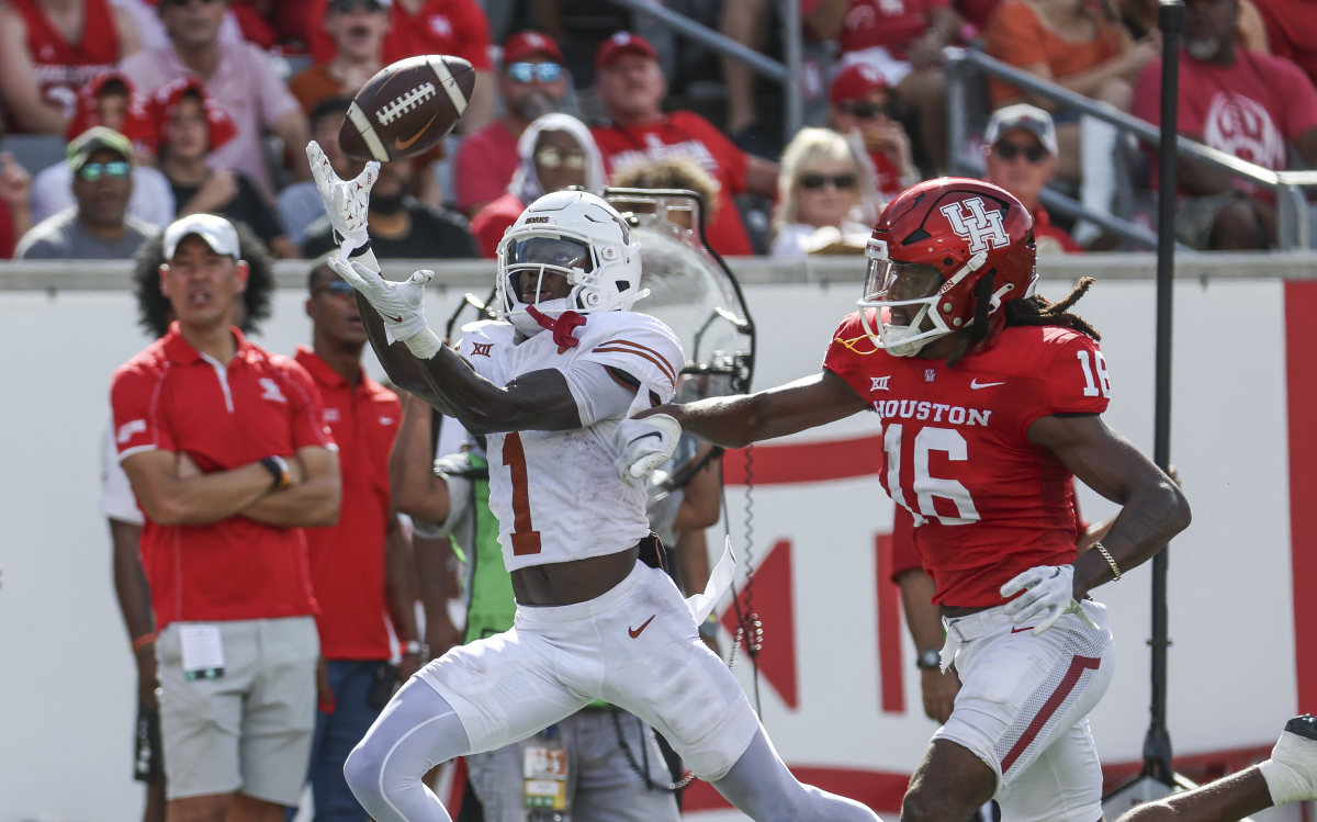 Texas Longhorns wide receiver Xavier Worthy (1) makes a reception for a touchdown as Houston Cougars defensive back Brian George (16) defends during the first quarter at TDECU Stadium.
