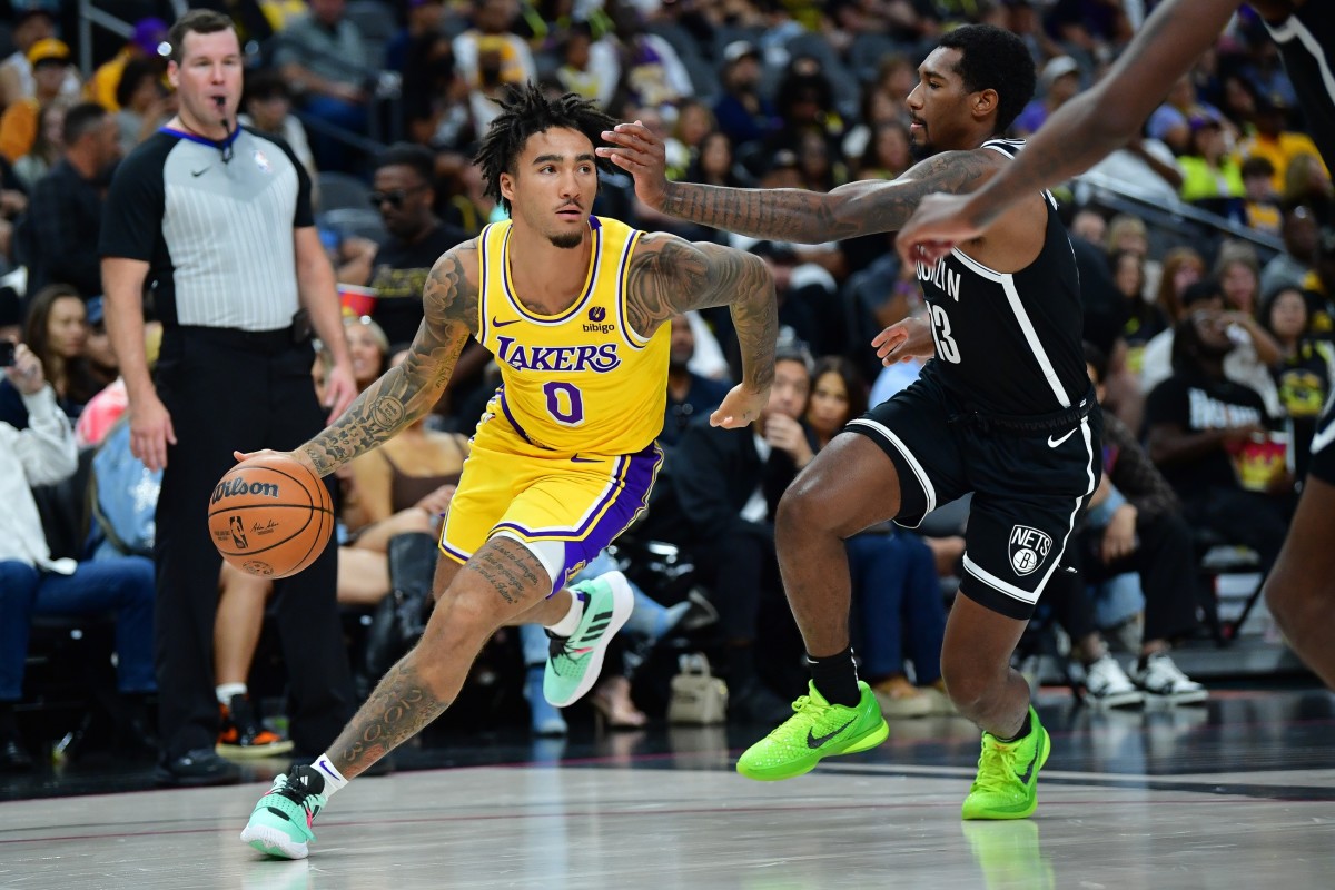 Los Angeles Lakers guard Jalen Hood-Schifino (0) moves the ball against Brooklyn Nets guard Armoni Brooks (13) during the second half at T-Mobile Arena.