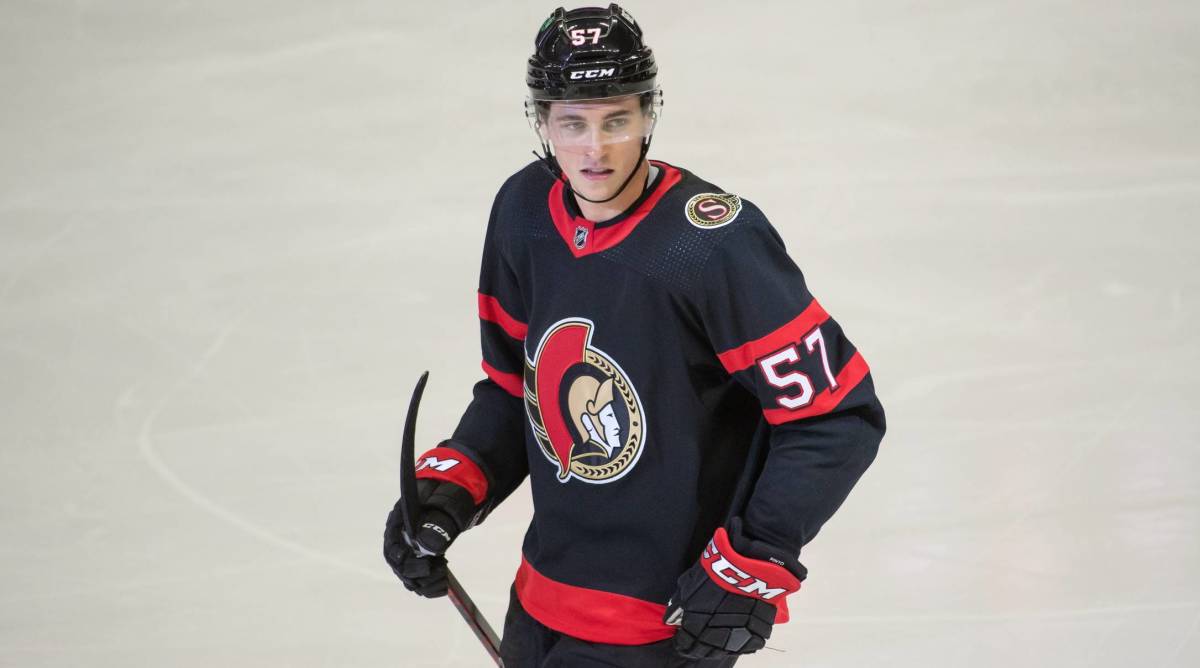 Senators center Shane Pinto looks while holding his stick on during a game.