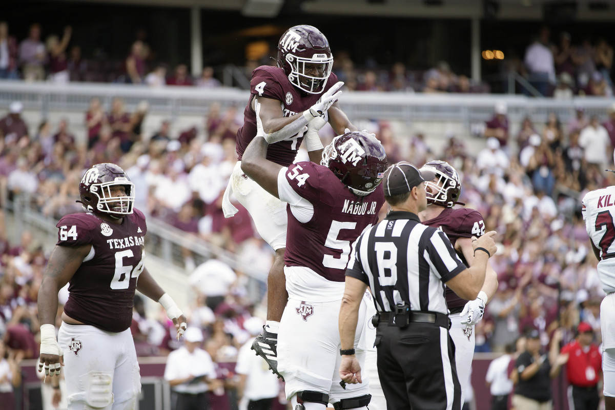 Oct 28, 2023; College Station, Texas, USA; Texas A&M Aggies running back Amari Daniels (4) and offensive lineman Mark Nabou Jr. (54) celebrate during the second quarter against the South Carolina Gamecocks at Kyle Field.