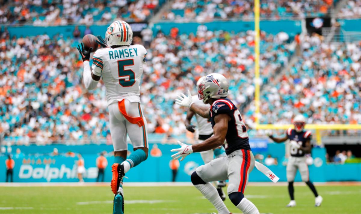 Miami Dolphins cornerback Jalen Ramsey (5) intercepts a pass intended to New England Patriots wide receiver Kendrick Bourne (84) during the second quarter at Hard Rock Stadium.
