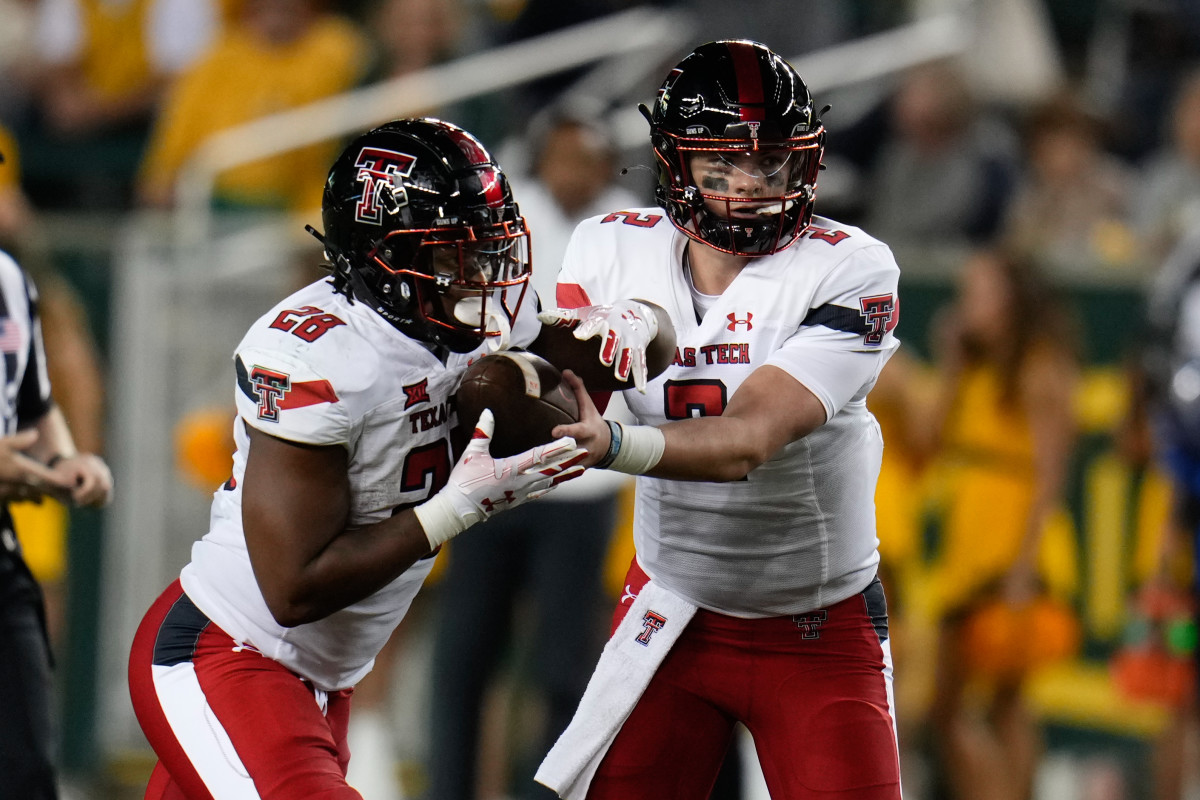 Oct 7, 2023; Waco, Texas, USA; Texas Tech Red Raiders quarterback Behren Morton (2) hands the ball off to Texas Tech Red Raiders running back Tahj Brooks (28) against the Baylor Bears during the second half at McLane Stadium. Mandatory Credit: Chris Jones-USA TODAY Sports