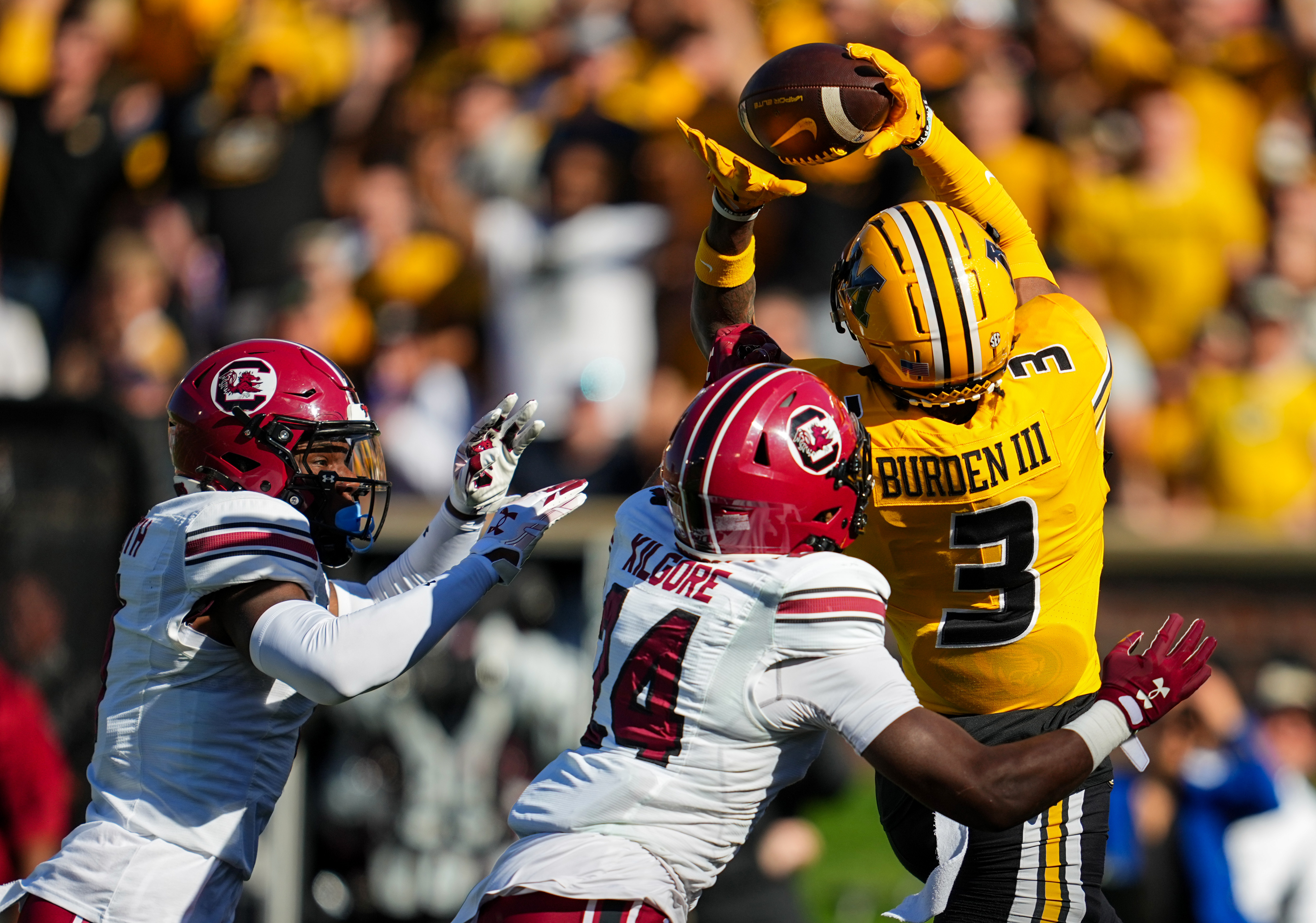 Oct 21, 2023; Columbia, Missouri, USA; Missouri Tigers wide receiver Luther Burden III (3) catches a touchdown pass against South Carolina Gamecocks defensive back Jalon Kilgore (24) and defensive back DQ Smith (1) during the first half at Faurot Field at Memorial Stadium. (Jay Biggerstaff / USA TODAY Sports)