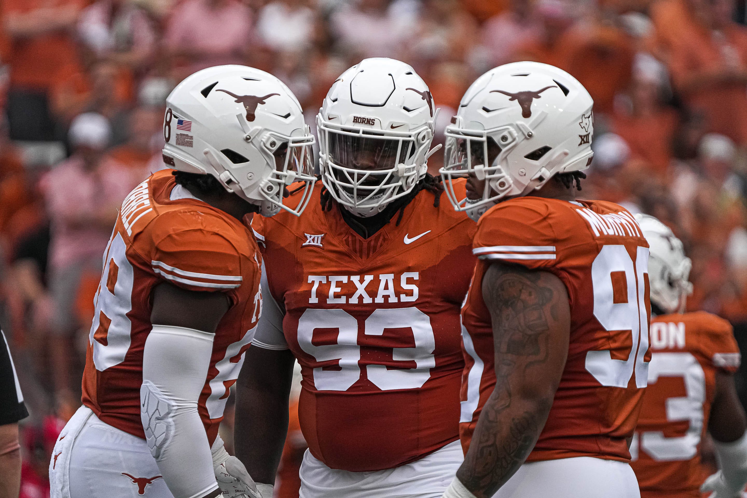 Texas Longhorns defensive lineman T'Vondre Sweat (93), center, huddles with teammates during the game against Kansas State at Royal-Memorial Stadium on Saturday, Nov. 4, 2023 in Austin.