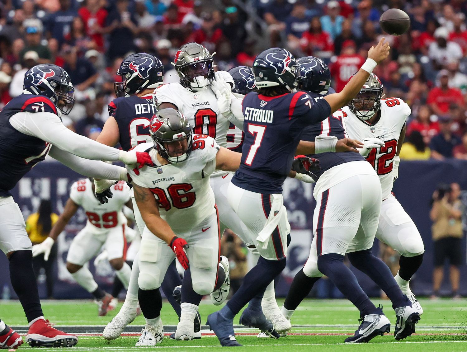 C.J. Stroud releases the ball in a throw as a Bucs defender reaches for him