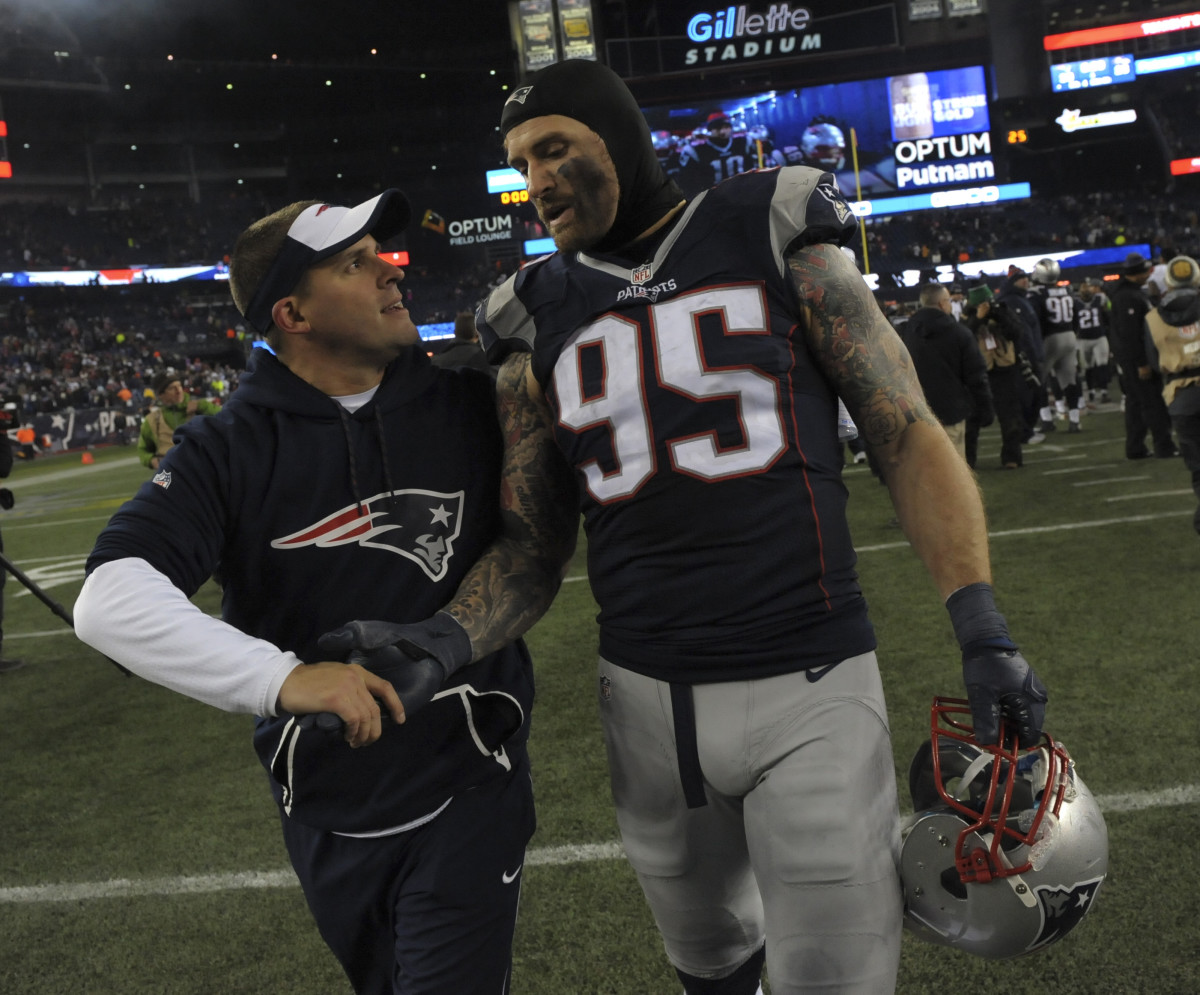 Dec 12, 2016; Foxborough, MA, USA; New England Patriots offensive coordinator Josh McDaniels congratulates defensive end Chris Long (95) after defeating the Baltimore Ravens at Gillette Stadium. 