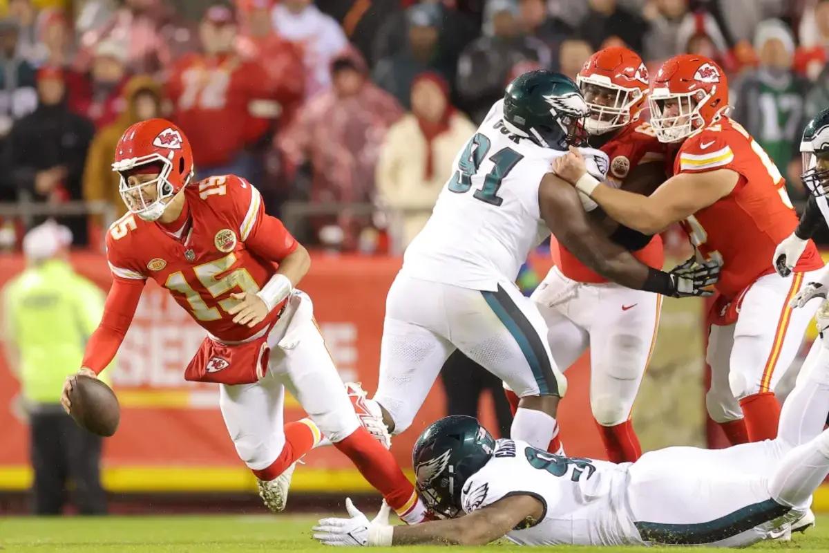 Philadelphia Eagles rookie Jalen Carter takes down Kansas City Chiefs quarterback Patrick Mahomes with an ankle tackle. 