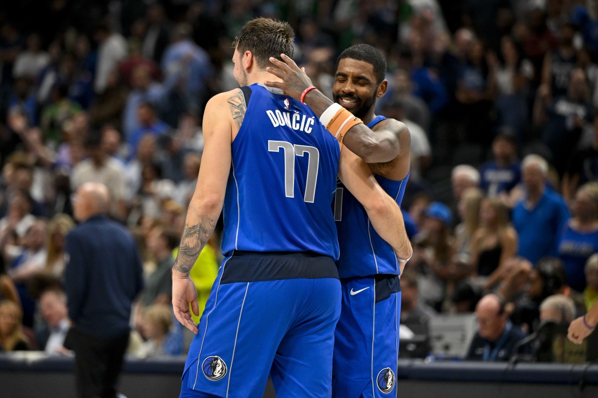 Mavs' Luka Doncic and Kyrie Irving share an embrace against the Charlotte Hornets.