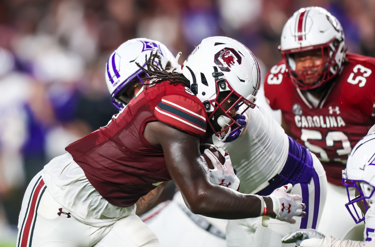 Dakereon Joyner lowering the shoulder against a Furman Paladin defender (9th Sept., 2023)