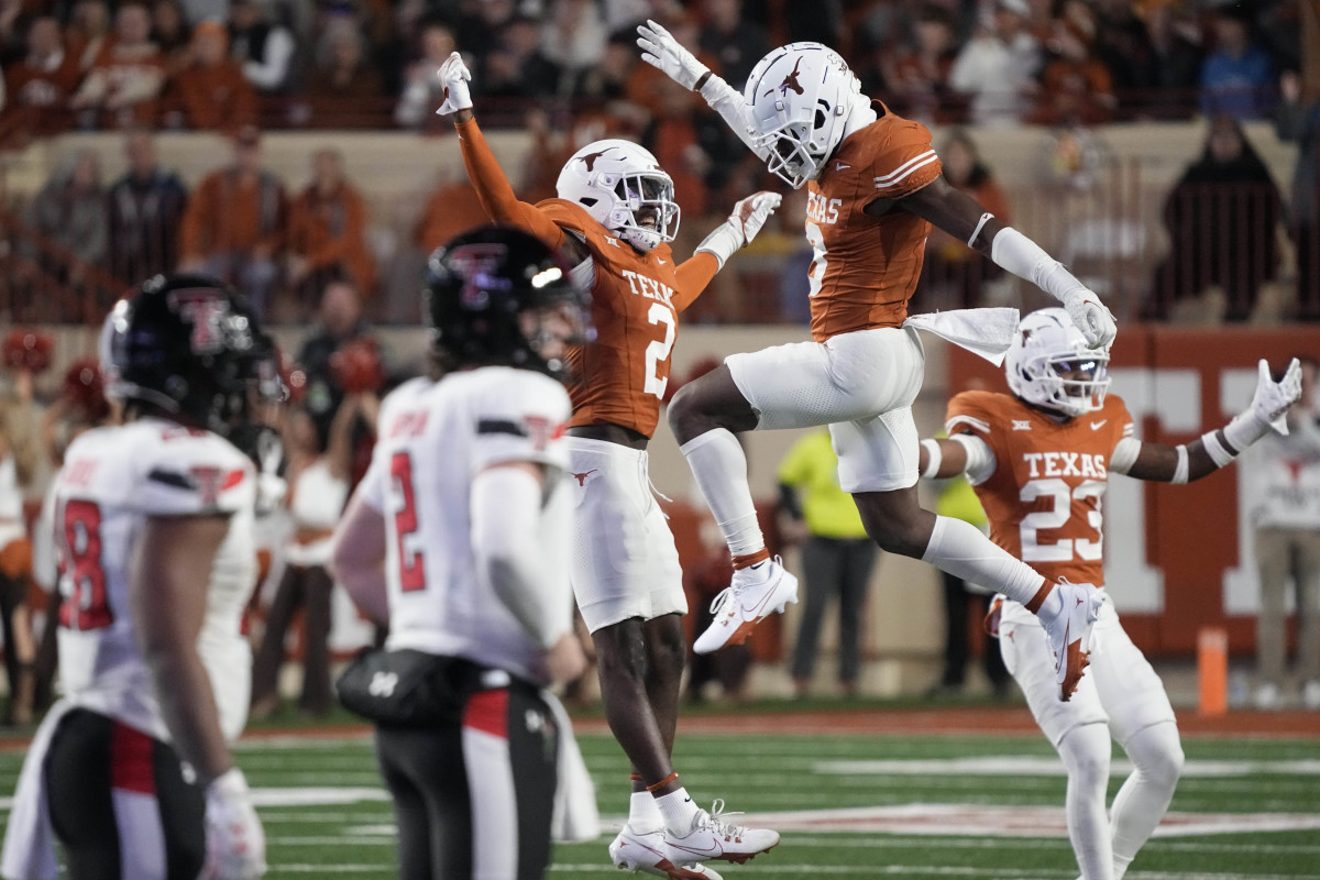 Nov 24, 2023; Austin, Texas, USA; Texas Longhorns defensive backs Terrance Brooks (8) and Derek Williams Jr. (2) celebrate after Brooks made an interception during the first half against the Texas Tech Red Raiders at Darrell K Royal-Texas Memorial Stadium. 