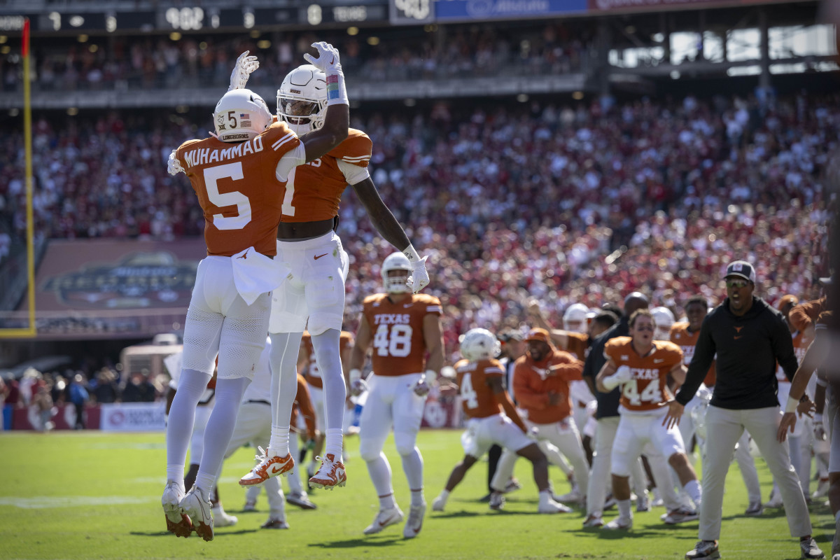 Oct 7, 2023; Dallas, Texas, USA; Texas Longhorns defensive back Malik Muhammad (5) and wide receiver Xavier Worthy (1) celebrate a touchdown against the Oklahoma Sooners during the first half at the Cotton Bowl. Mandatory Credit: Jerome Miron-USA TODAY Sports 