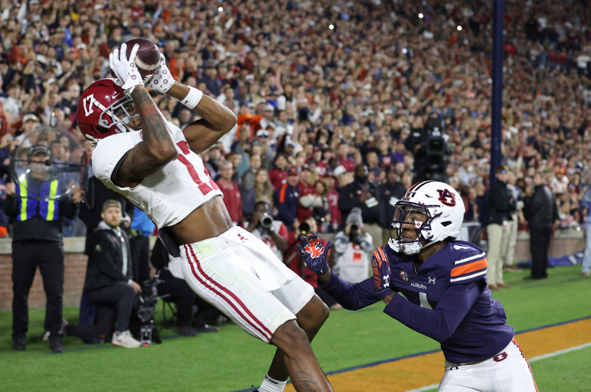 Nov 25, 2023; Auburn, Alabama, USA; Alabama Crimson Tide wide receiver Isaiah Bond (17) scores the game winning touchdown over Auburn Tigers cornerback D.J. James (4) during the fourth quarter at Jordan-Hare Stadium.