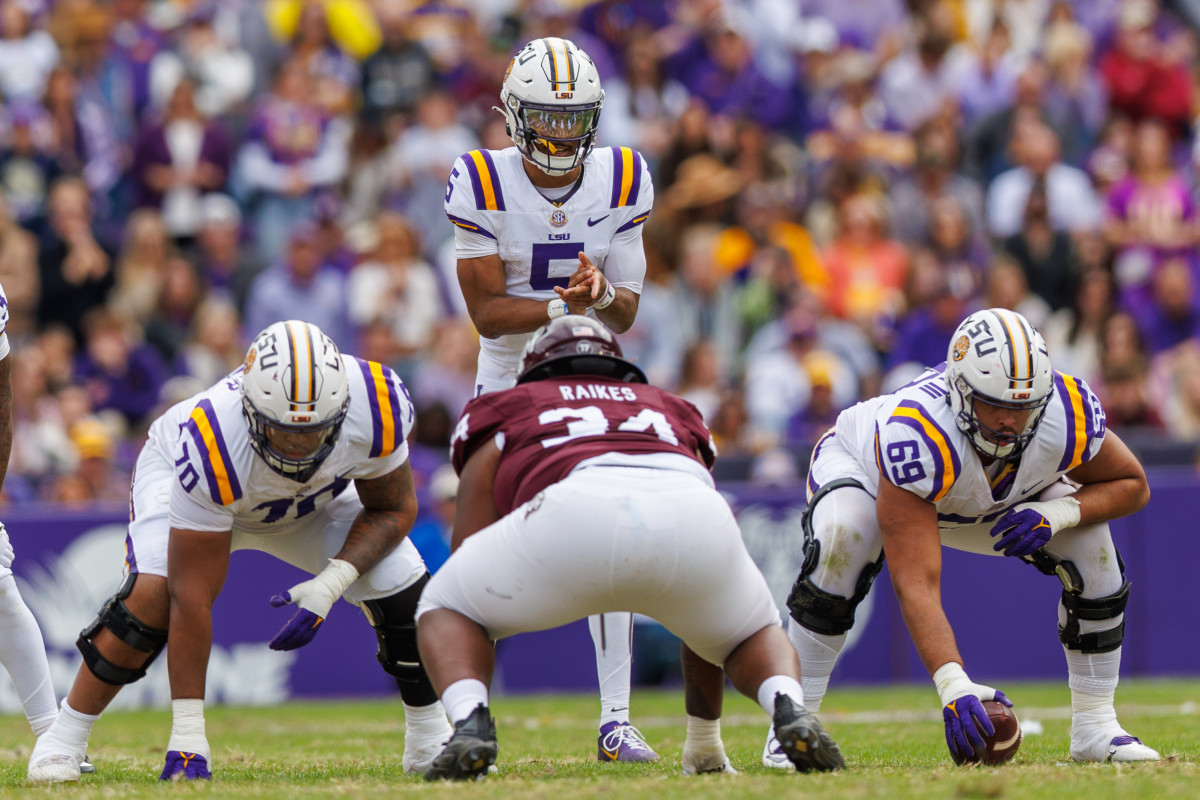 Nov 25, 2023; Baton Rouge, Louisiana, USA; LSU Tigers quarterback Jayden Daniels (5) calls for the ball against Texas A&M Aggies defensive lineman Isaiah Raikes (34) during the second half at Tiger Stadium.