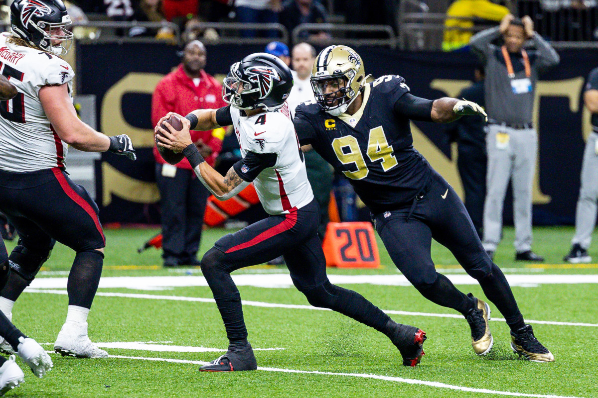 Dec 18, 2022; New Orleans, Louisiana, USA; New Orleans Saints defensive end Cameron Jordan (94) sacks Atlanta Falcons quarterback Desmond Ridder (4) but it called back for a fack mask penalty during the second half at Caesars Superdome. 