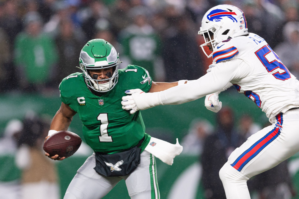 Philadelphia Eagles quarterback Jalen Hurts (1) eludes Buffalo Bills defensive end Leonard Floyd (56) during the first quarter at Lincoln Financial Field.