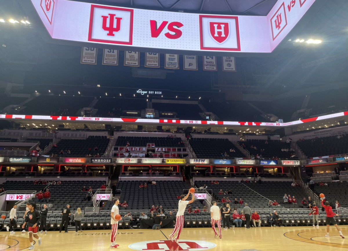 Trey Galloway, Anthony Leal and Gabe Cupps attempt half-court shots before Indiana's game against Harvard.