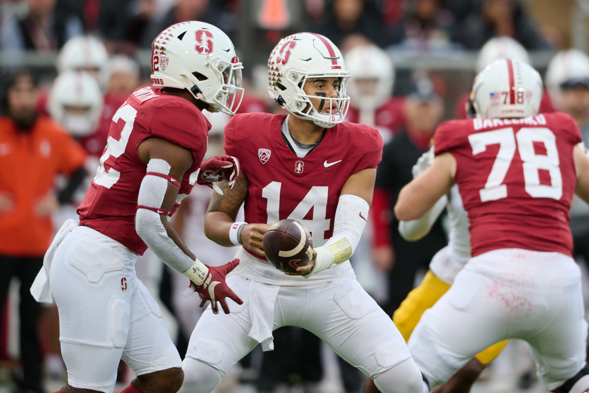 Nov 18, 2023; Stanford, California, USA; Stanford Cardinal quarterback Ashton Daniels (14) hands the ball to Stanford Cardinal running back E.J. Smith (22) against the California Golden Bears during the first quarter at Stanford Stadium. Mandatory Credit: Robert Edwards-USA TODAY Sports
