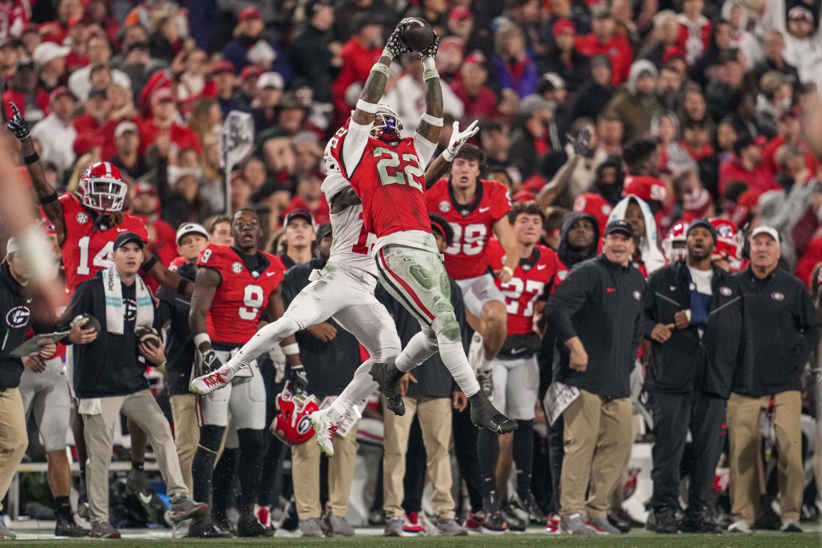Nov 11, 2023; Athens, Georgia, USA; Georgia Bulldogs defensive back Javon Bullard (22) intercepts a pass over the top of Mississippi Rebels wide receiver Dayton Wade (19) during the first half at Sanford Stadium. Mandatory Credit: Dale Zanine-USA TODAY Sports