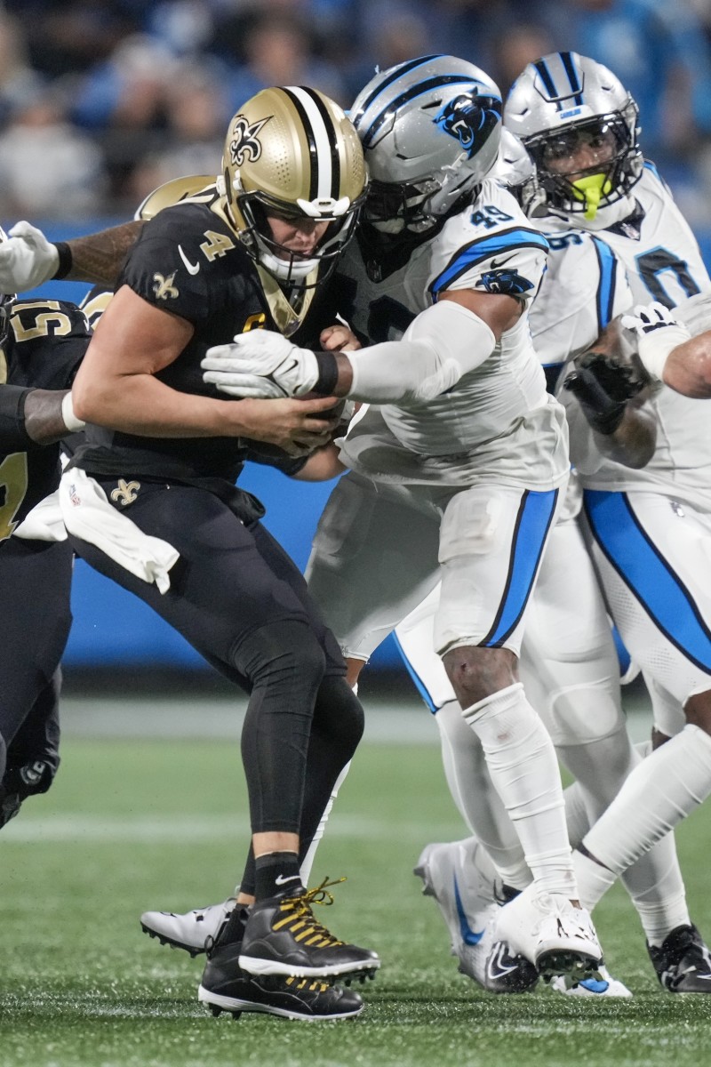 New Orleans Saints quarterback Derek Carr (4) is sacked by Carolina Panthers linebacker Frankie Luvu (49). Mandatory Credit: Jim Dedmon-USA TODAY