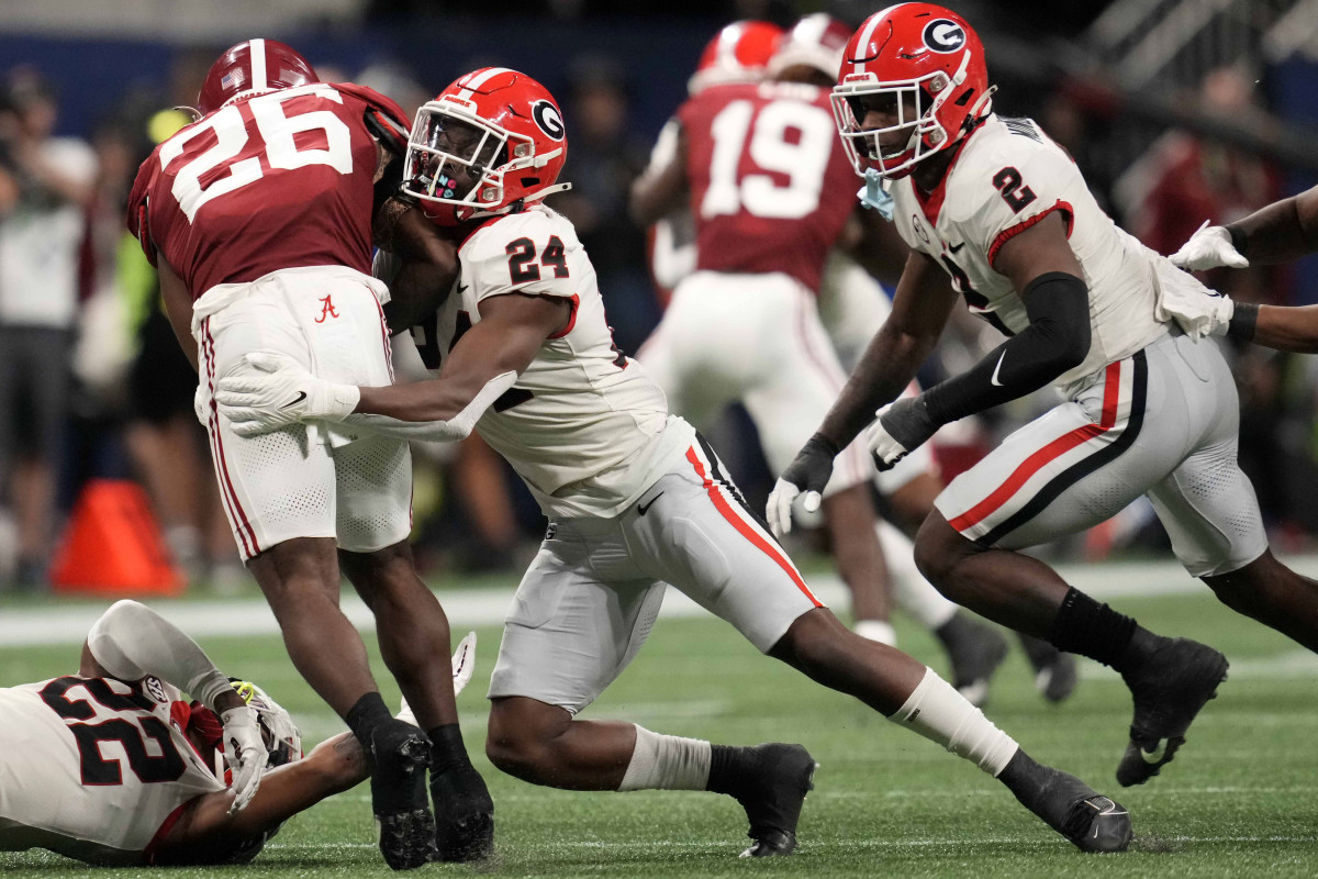 Dec 2, 2023; Atlanta, GA, USA; Georgia Bulldogs defensive back Malaki Starks (24) makes a tackle on Alabama Crimson Tide running back Jam Miller (26) during the second half in the SEC Championship game at Mercedes-Benz Stadium. (Dale Zanine / USA TODAY Sports).