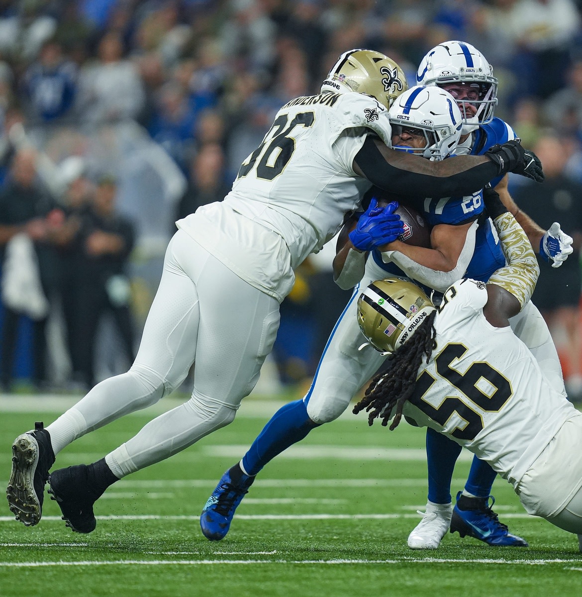 Oct. 29, 2023; New Orleans Saints defensive end Carl Granderson (96) and linebacker Demario Davis (56) tackle Indianapolis Colts running back Jonathan Taylor (28). © Jenna Watson/IndyStar / USA TODAY NETWORK