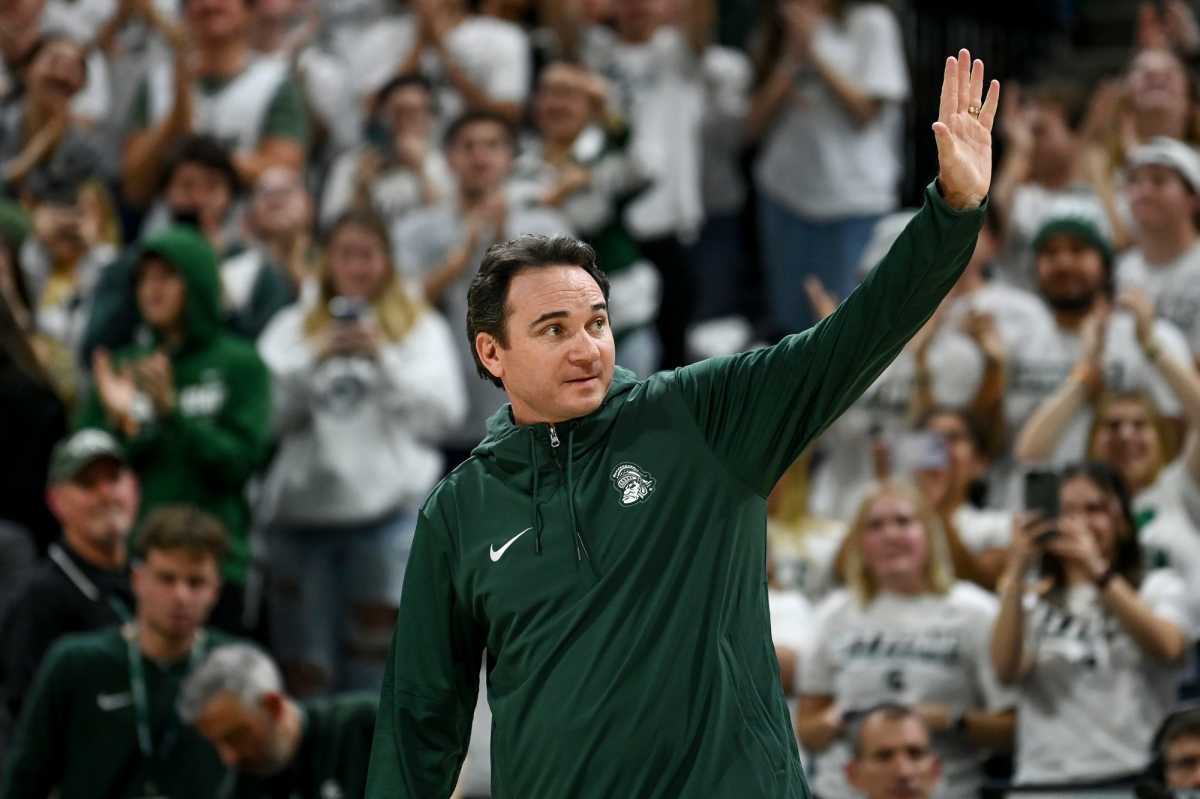 Michigan State's new football coach Jonathan Smith waves to the crowd during a timeout in the basketball game against Georgia Southern on Tuesday, Nov. 28, 2023, at the Breslin Center in East Lansing.