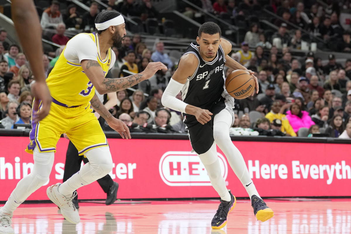 San Antonio Spurs center Victor Wembanyama (1) dribbles against Los Angeles Lakers forward Anthony Davis (3) in the first half at the Frost Bank Center.