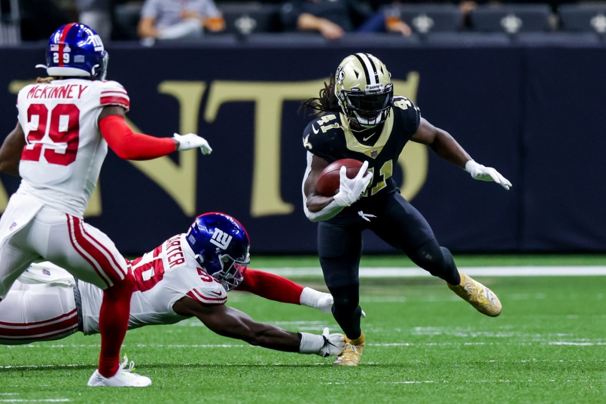 Oct 3, 2021; New Orleans Saints running back Alvin Kamara (41) runs away from the grasp of New York Giants linebacker Lorenzo Carter (59). Mandatory Credit: Stephen Lew-USA TODAY